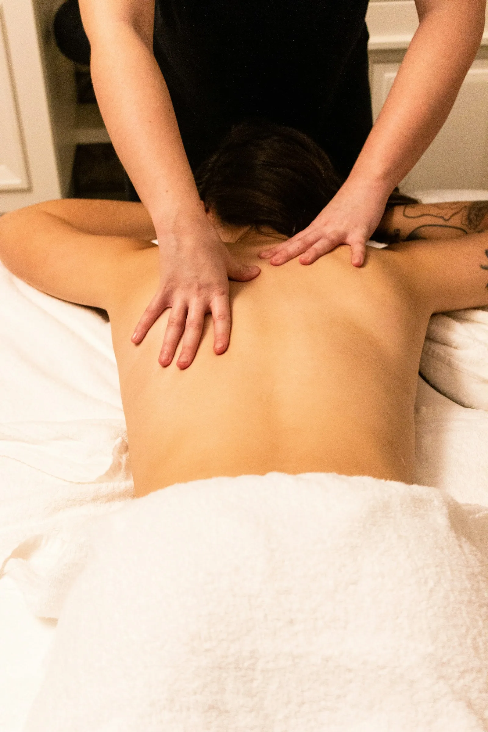 A woman resting peacefully during a therapeutic home massage session in Delhi